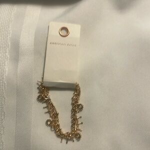 American Eagle triple strand gold tone bracelet